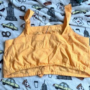 I am selling this yellowish top. It still has the tag on it.